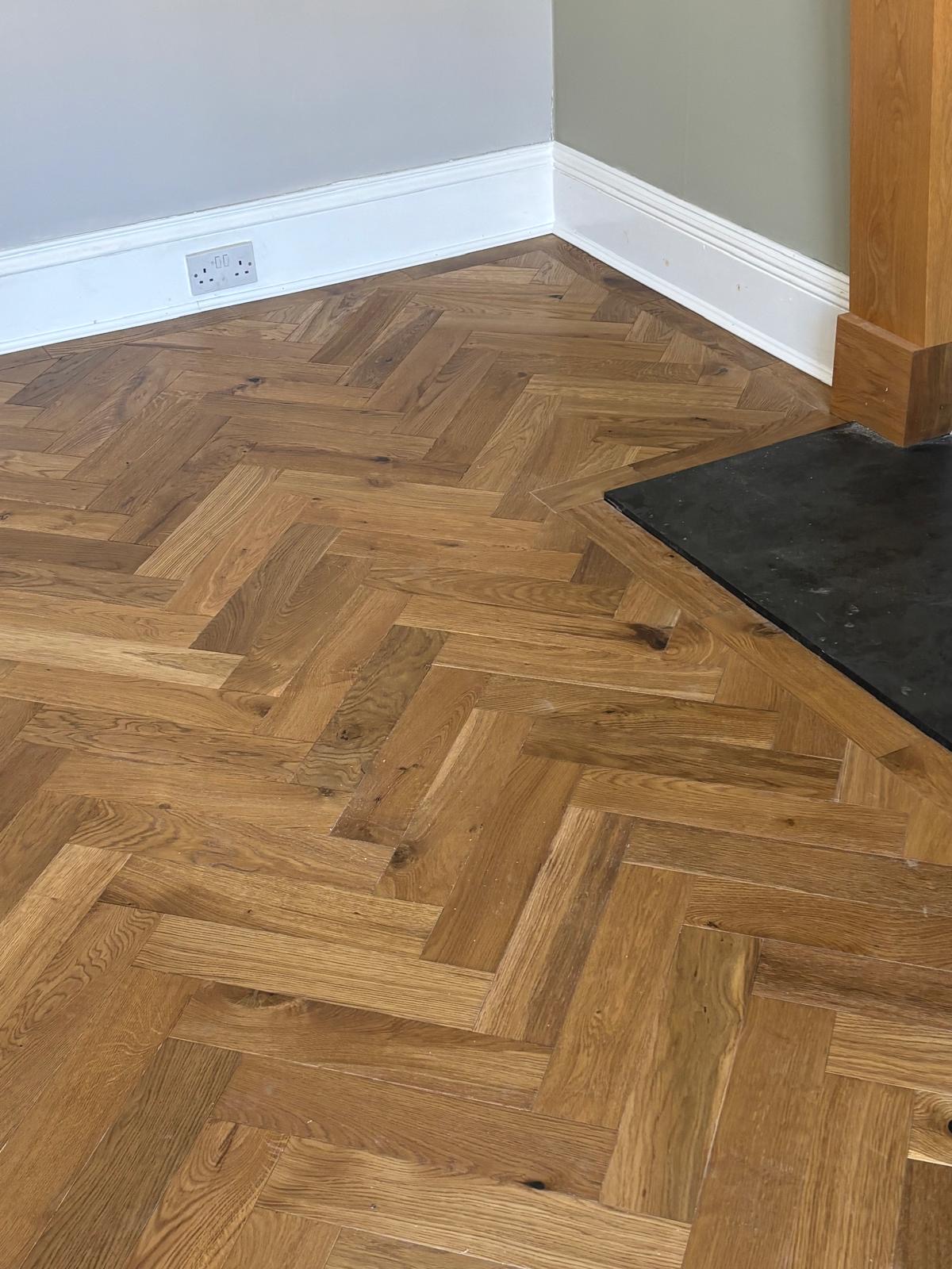 Timber border meeting the corner of a dark hearth