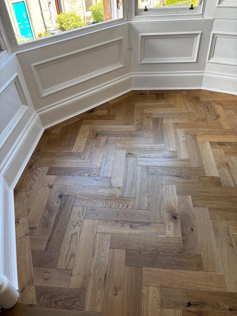 Herringbone flooring following the angled bay window in Haddington