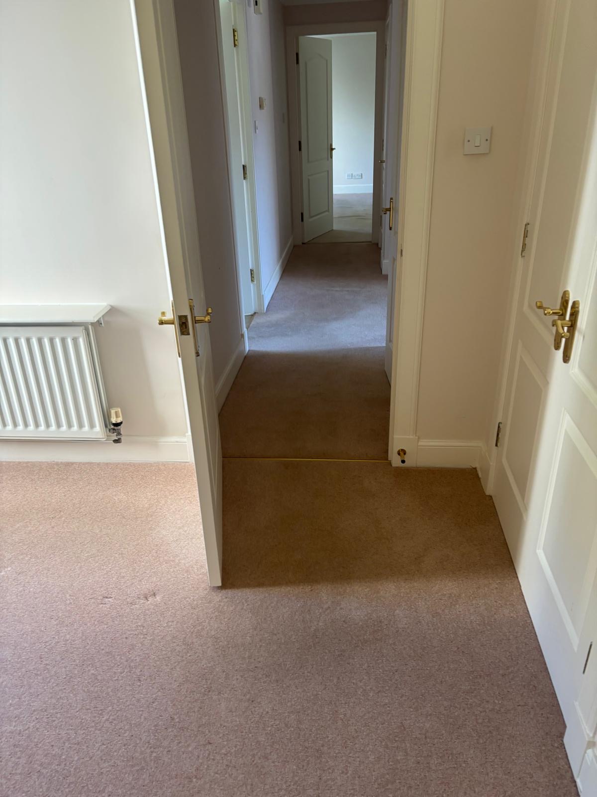 Carpeted hallway and doorway before the flooring transformation in Gullane